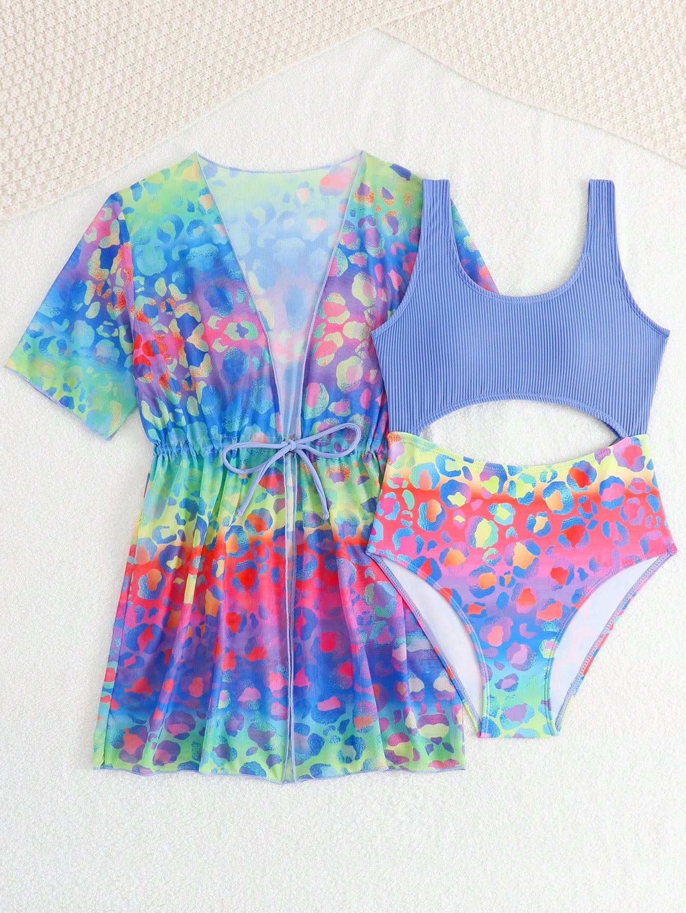 Tween girls multicolor 2-piece swimsuit set with scoop neck, cut-out details, patterned design, shorts-style bottoms, and sheer UV protection cover-up for beach and pool vacations.