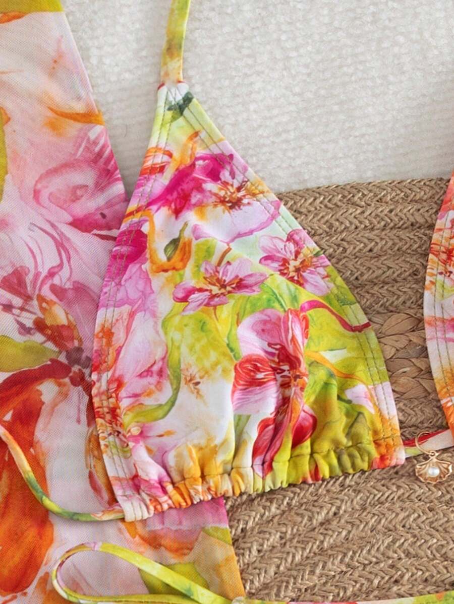 Women's 3-piece floral swimsuit set featuring a multicolor tie-back halter bikini top, low-waist bottoms, and a matching sheer mesh maxi skirt.