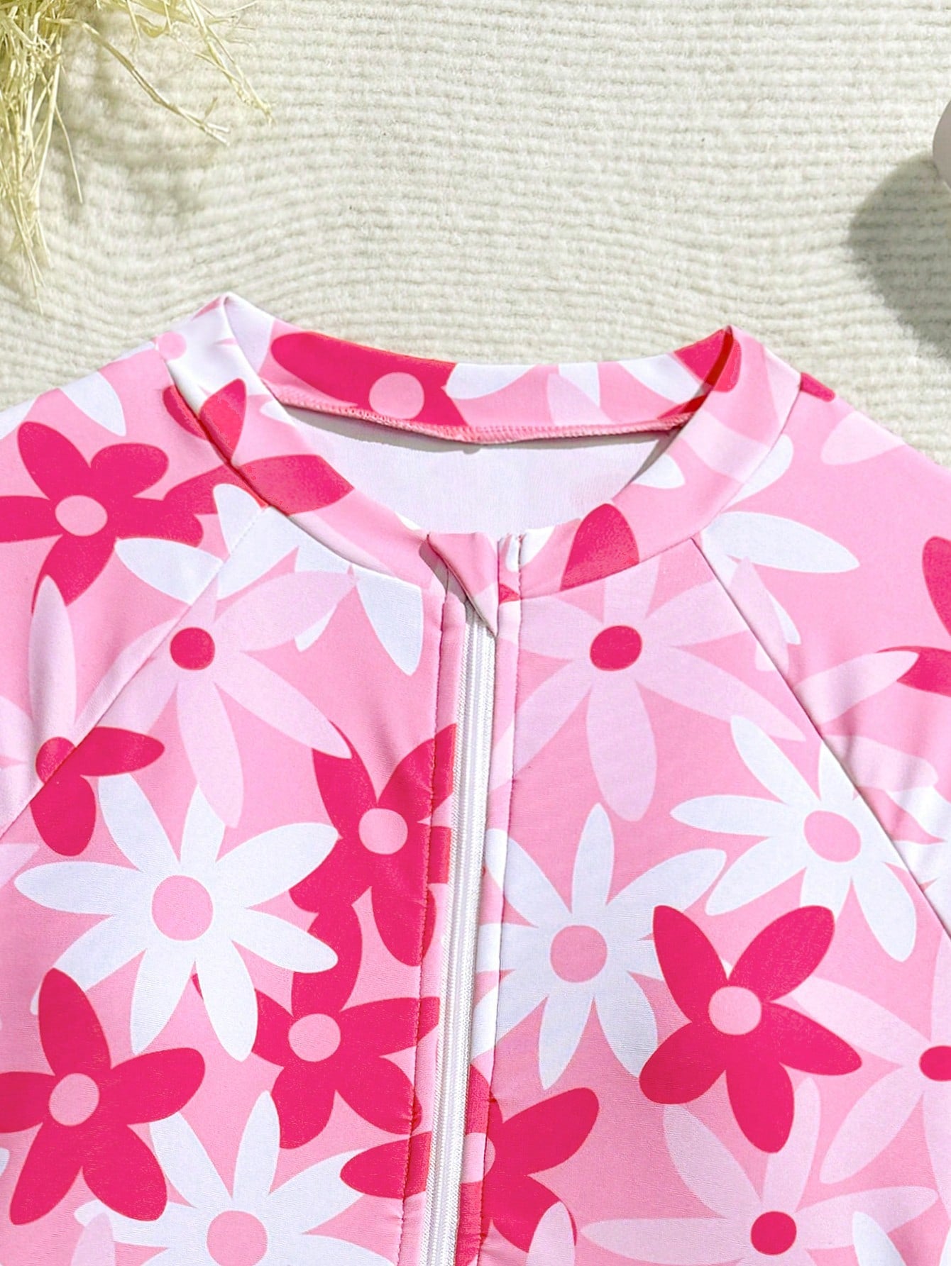 Girls' floral one-piece swimsuit with ruffle trim, high neck, and zipper front for beach and resort wear
