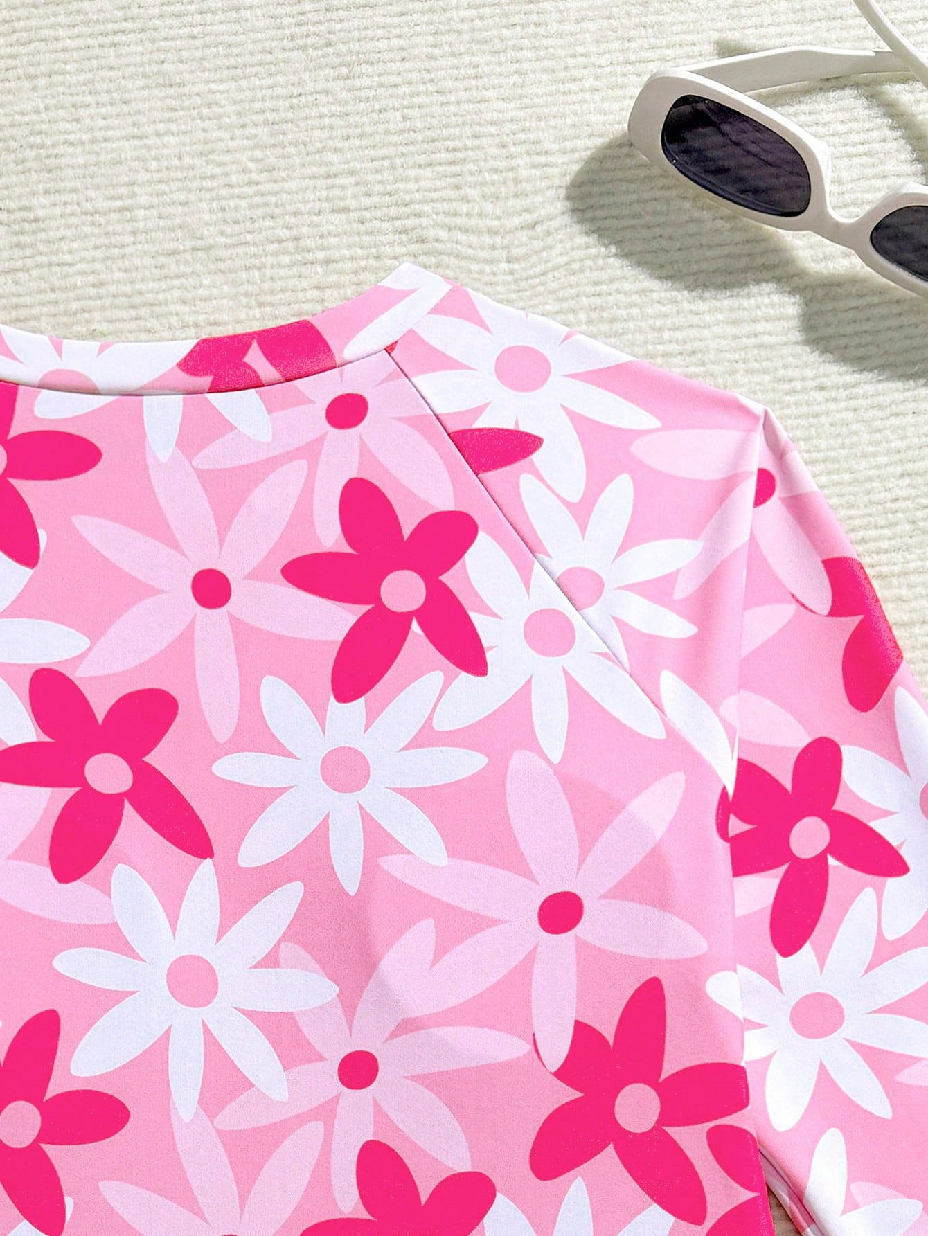 Girls' floral one-piece swimsuit with ruffle trim, high neck, and zipper front for beach and resort wear