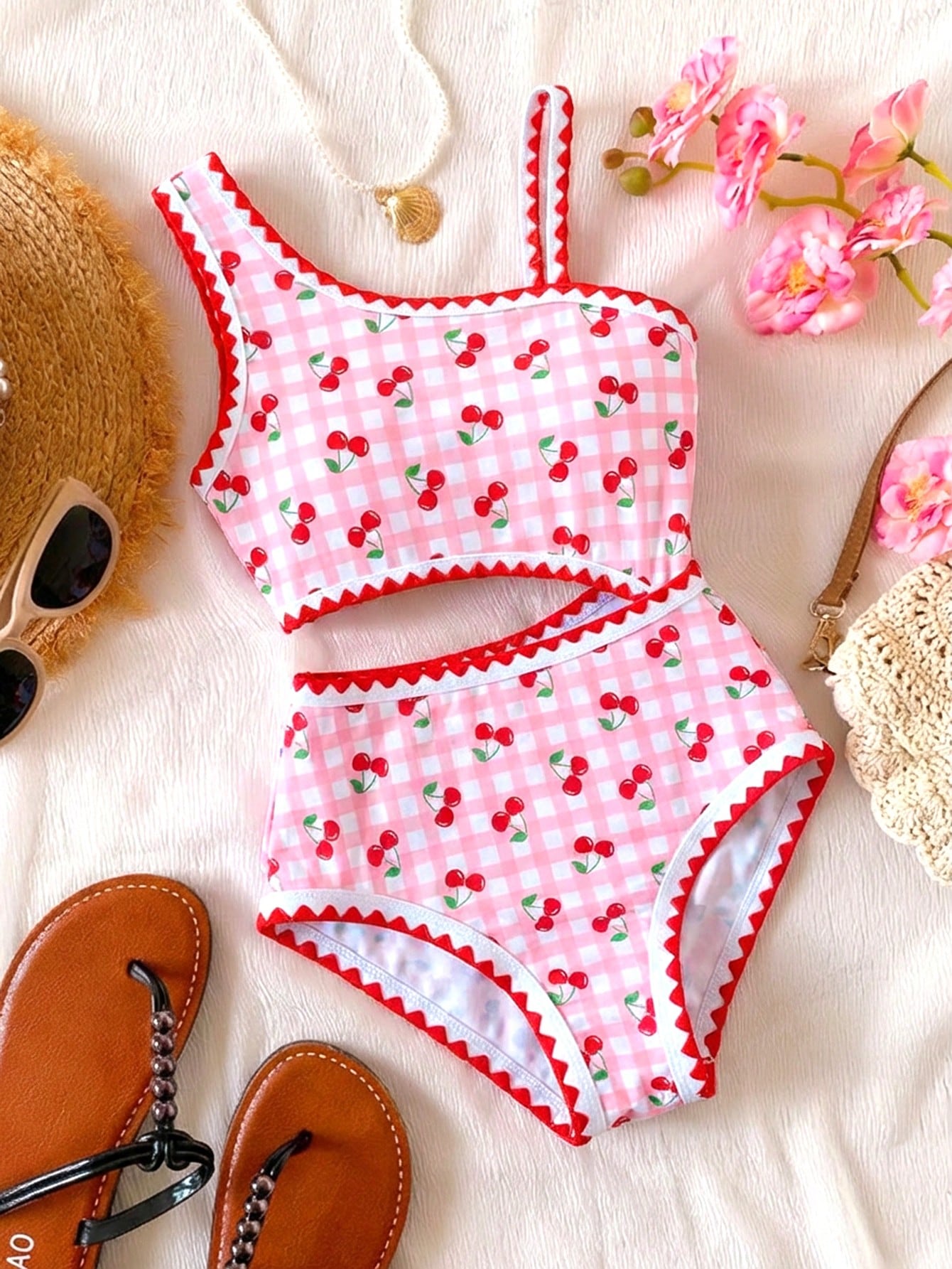 Tween girls one-piece swimsuit featuring an asymmetric neckline, pendant decor, plain design, wireless bra, high-cut bottom, and medium-stretch fabric.