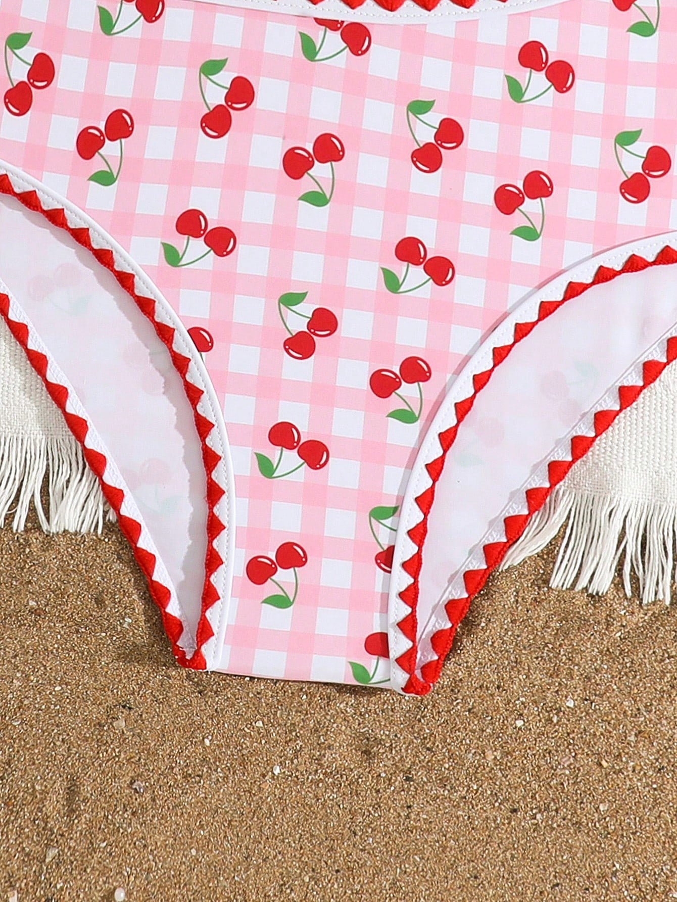 Tween girls one-piece swimsuit featuring an asymmetric neckline, pendant decor, plain design, wireless bra, high-cut bottom, and medium-stretch fabric.