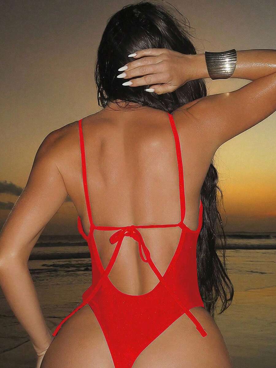 Women's black lace one-piece swimsuit featuring a deep V-neckline, spaghetti straps, backless tie-up detail, and thong bottom.