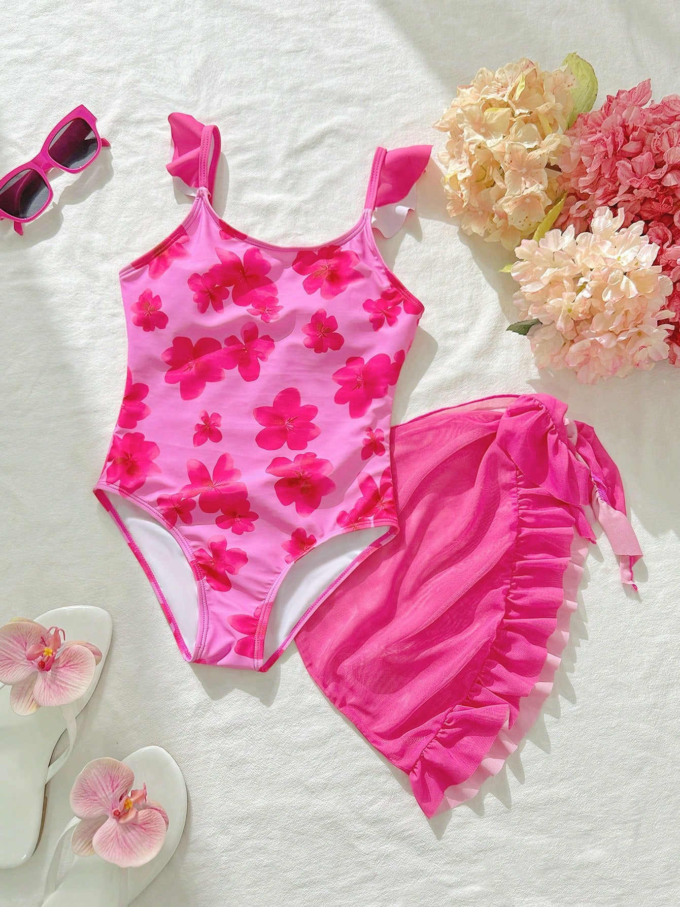 Tween girls one-piece swimsuit in leopard print with ruffle shoulder straps, scoop neckline, fitted shape, and attached ruffle hem skirt; sleeveless, mid-waist skirt bottom, and lined body for swimming, vacation, and summer beach wear.