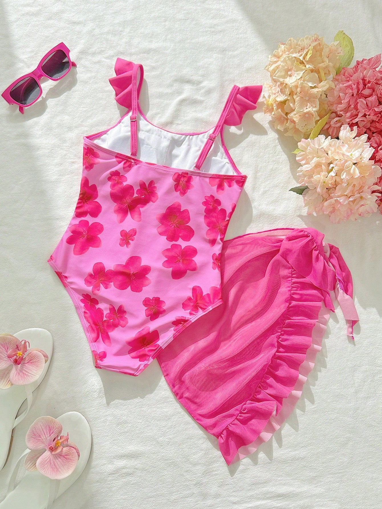 Tween girls one-piece swimsuit in leopard print with ruffle shoulder straps, scoop neckline, fitted shape, and attached ruffle hem skirt; sleeveless, mid-waist skirt bottom, and lined body for swimming, vacation, and summer beach wear.