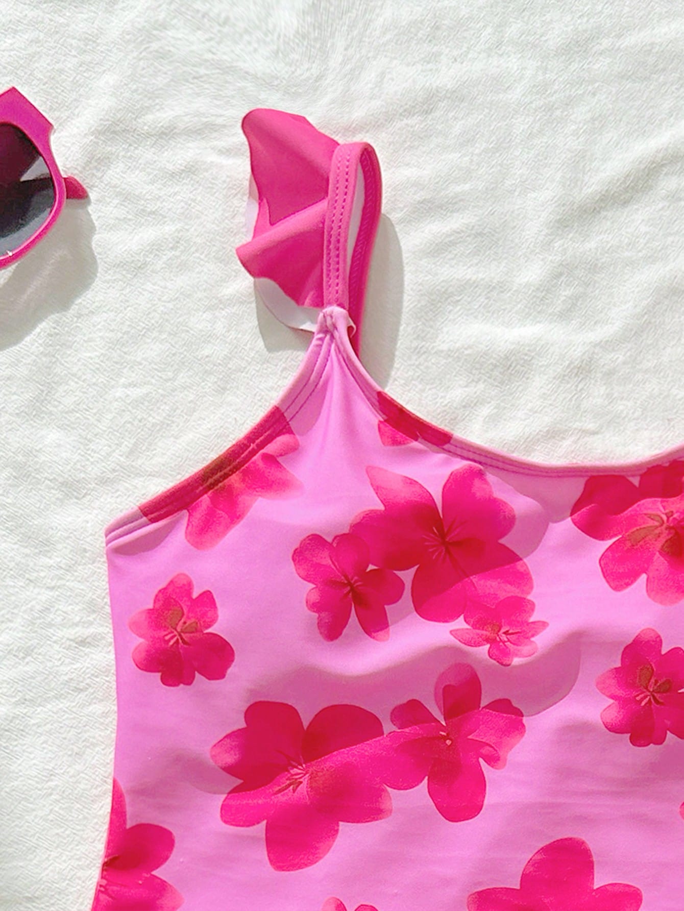 Tween girls one-piece swimsuit in leopard print with ruffle shoulder straps, scoop neckline, fitted shape, and attached ruffle hem skirt; sleeveless, mid-waist skirt bottom, and lined body for swimming, vacation, and summer beach wear.