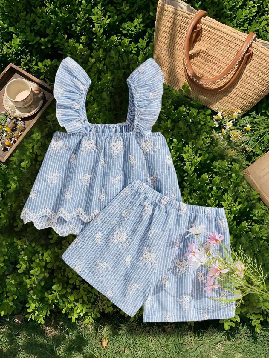 Tween girl wearing a blue and white striped sleeveless top featuring embroidery details and ruffle trim with matching shorts.