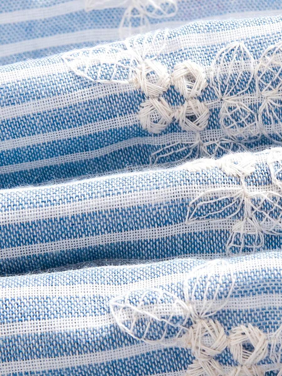 Tween girl wearing a blue and white striped sleeveless top featuring embroidery details and ruffle trim with matching shorts.