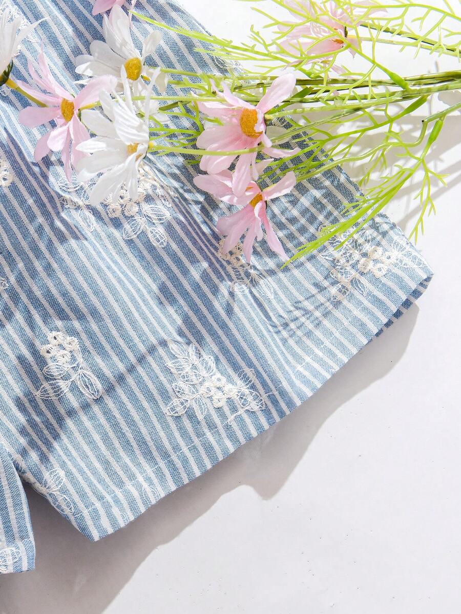 Tween girl wearing a blue and white striped sleeveless top featuring embroidery details and ruffle trim with matching shorts.