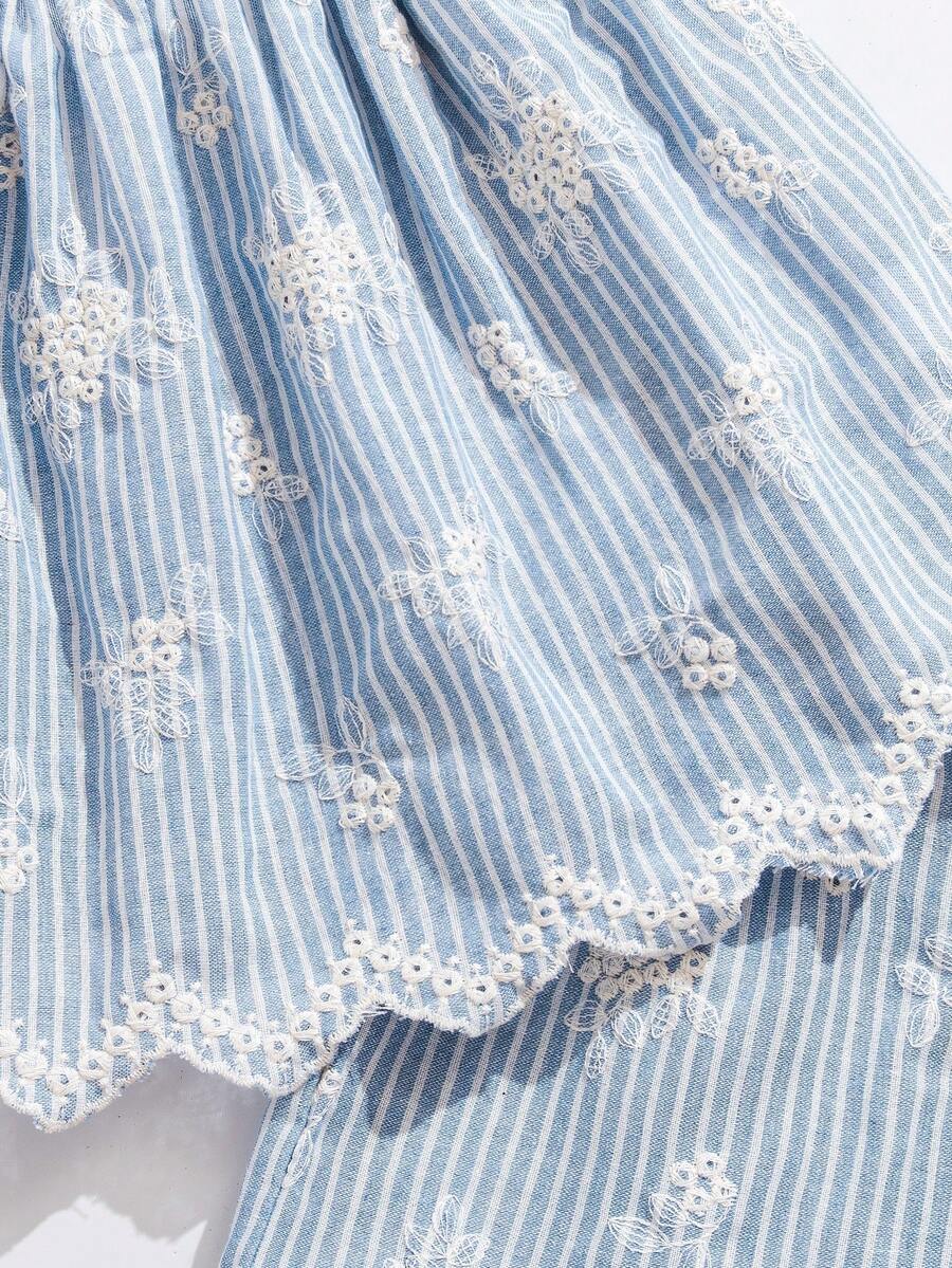 Tween girl wearing a blue and white striped sleeveless top featuring embroidery details and ruffle trim with matching shorts.