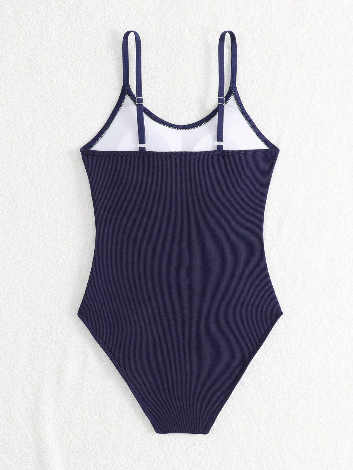Purple rib knit one-piece swimsuit for tween girls with spaghetti straps, fitted shape, mid-waist bottom, wireless bra, and lined body.