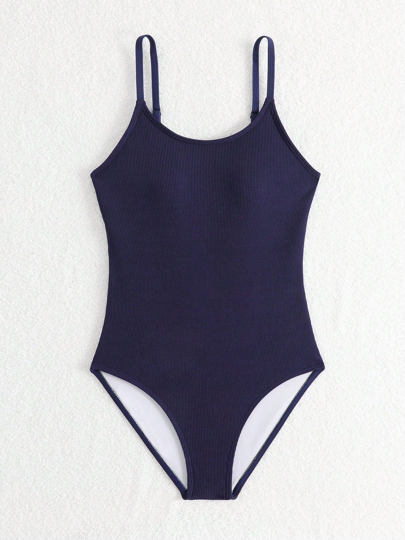 Purple rib knit one-piece swimsuit for tween girls with spaghetti straps, fitted shape, mid-waist bottom, wireless bra, and lined body.