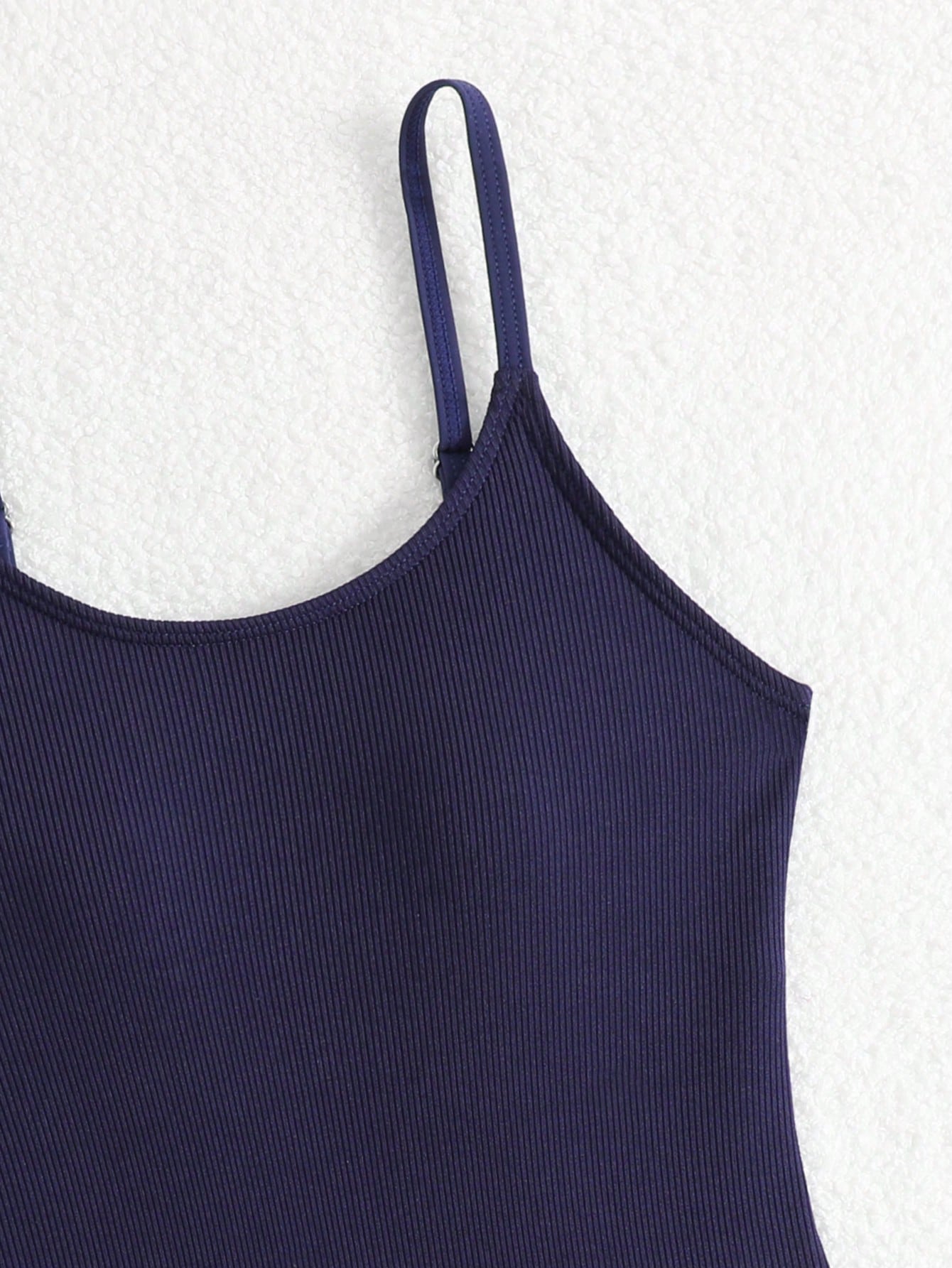 Purple rib knit one-piece swimsuit for tween girls with spaghetti straps, fitted shape, mid-waist bottom, wireless bra, and lined body.
