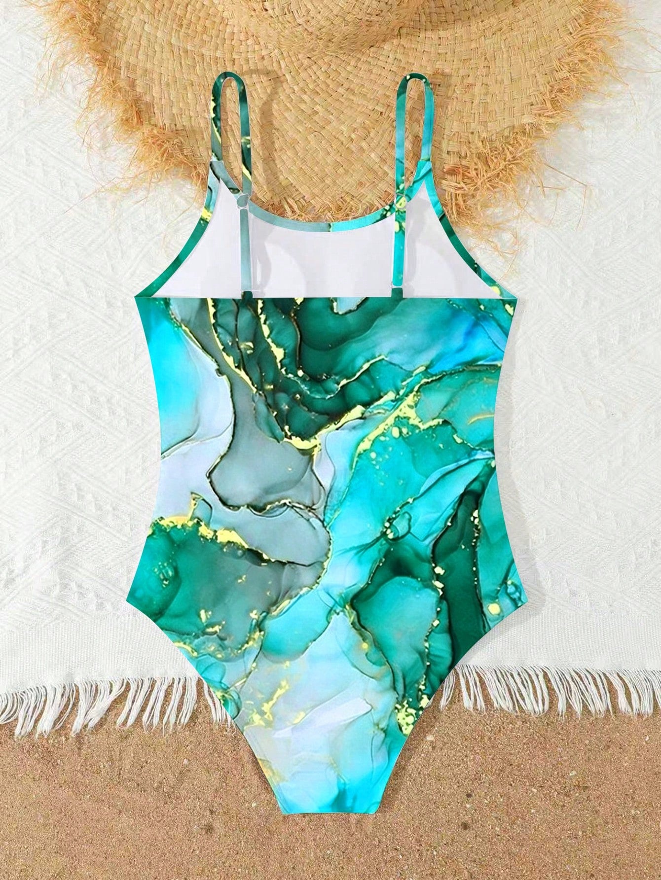 Tween girls one-piece swimsuit with multicolor ocean shell and seahorse all-over print, spaghetti straps, cut-out detail, and lined body for beach or swimming.