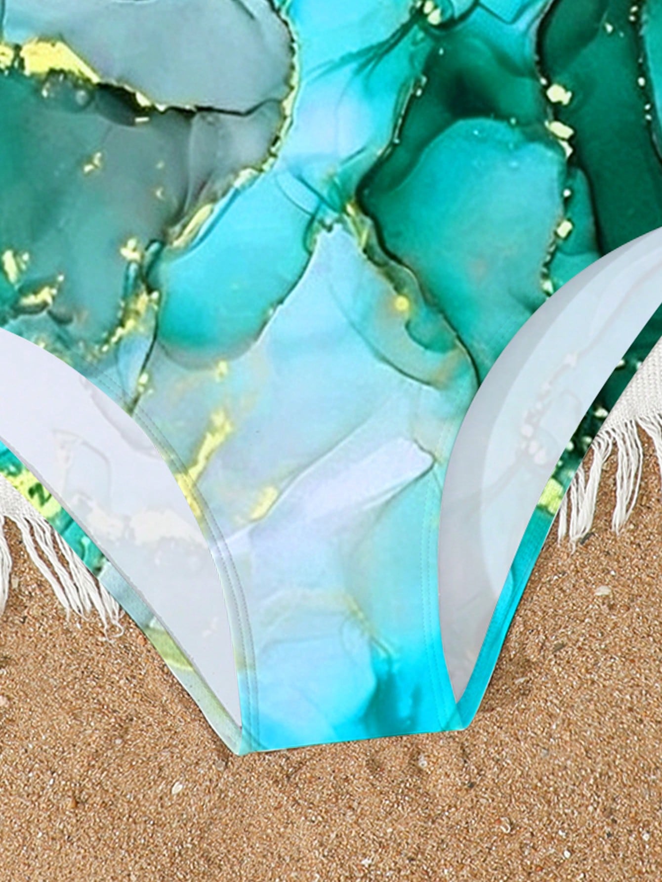 Tween girls one-piece swimsuit with multicolor ocean shell and seahorse all-over print, spaghetti straps, cut-out detail, and lined body for beach or swimming.