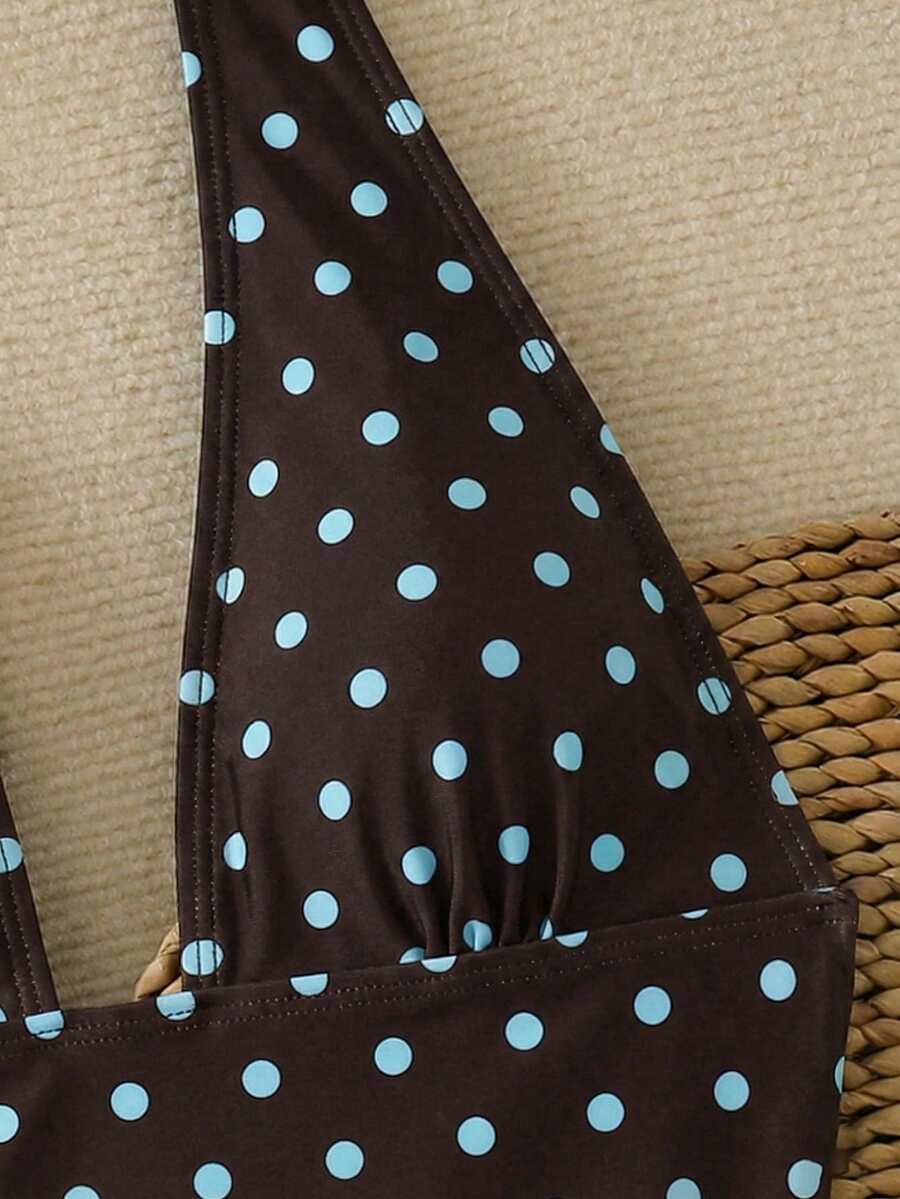 Women's apricot polka dot two-piece swimsuit featuring an asymmetrical halter backless top with knot tie detail and high-waisted bottoms.