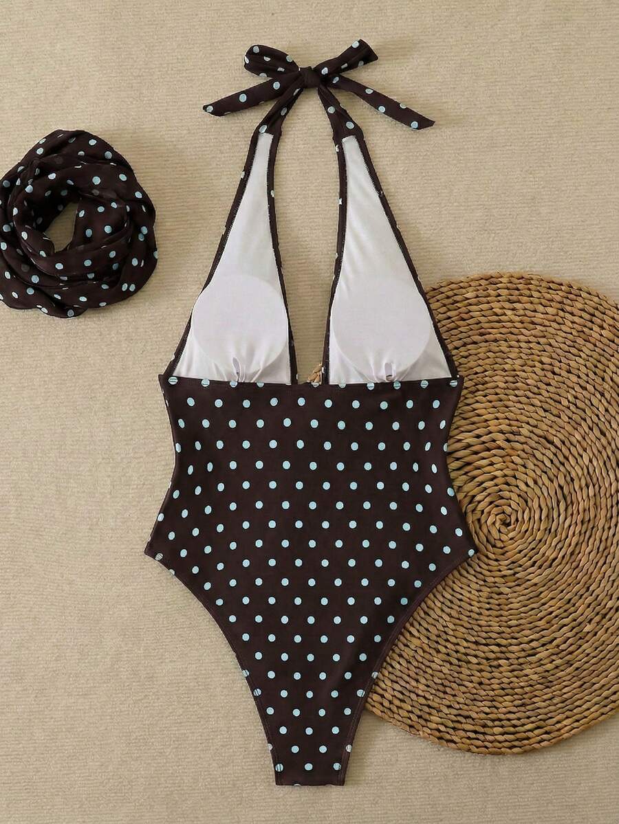 Women's apricot polka dot two-piece swimsuit featuring an asymmetrical halter backless top with knot tie detail and high-waisted bottoms.
