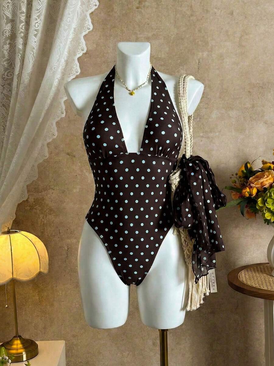 Women's apricot polka dot two-piece swimsuit featuring an asymmetrical halter backless top with knot tie detail and high-waisted bottoms.