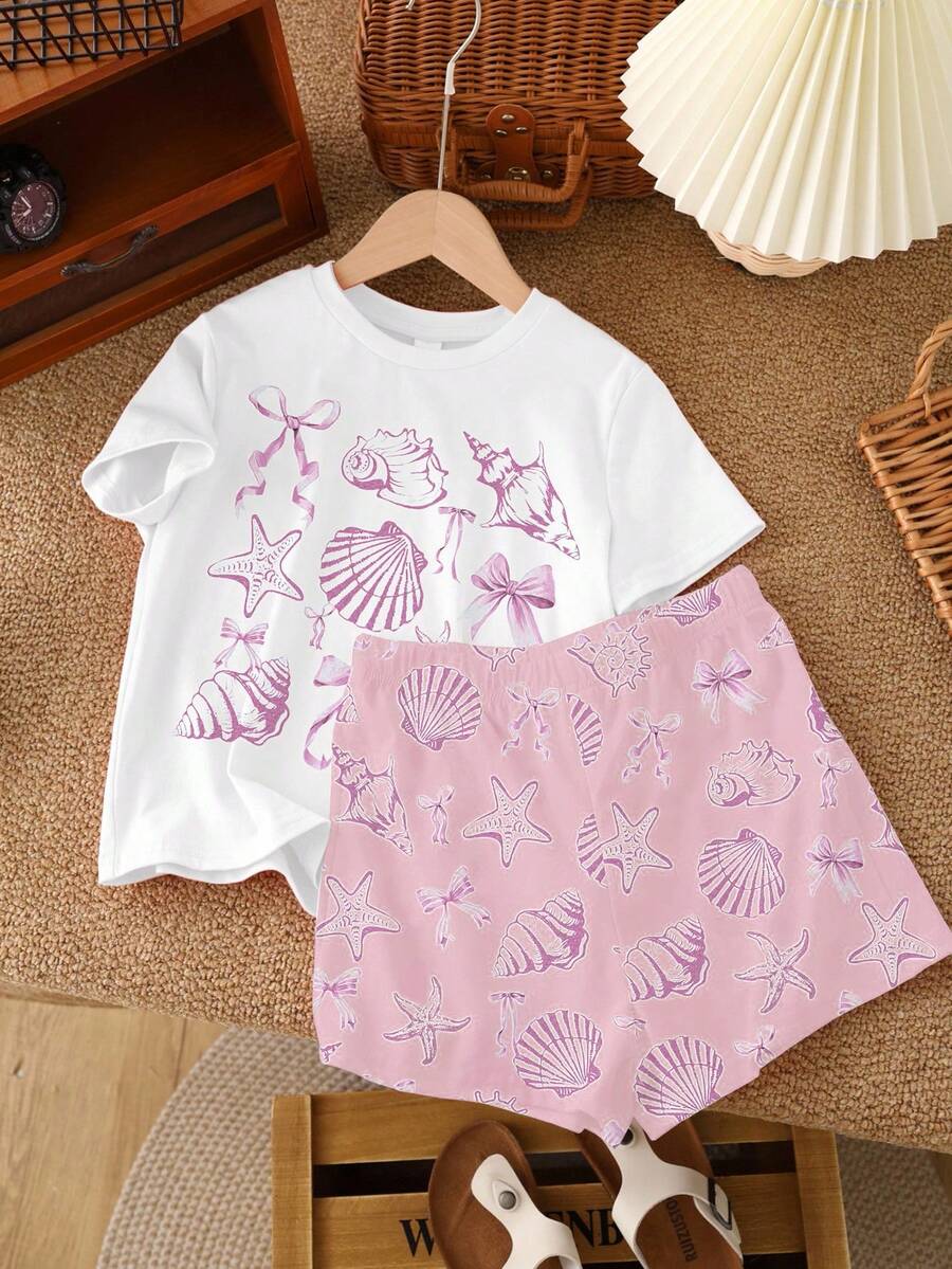 Teen girl wearing 2-piece summer vacation set with blue and white striped short sleeve top featuring seashell ocean bow print and matching loose fit shorts with pockets.