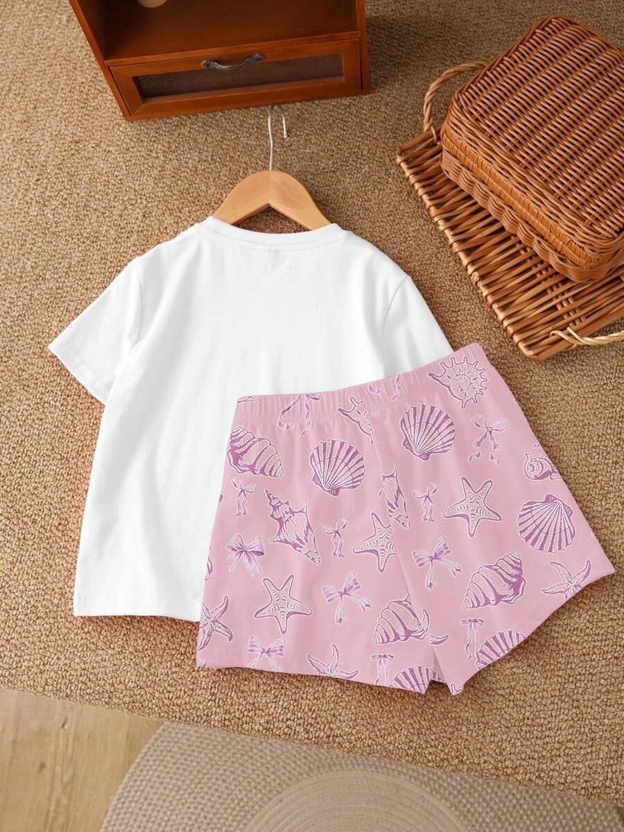 Teen girl wearing 2-piece summer vacation set with blue and white striped short sleeve top featuring seashell ocean bow print and matching loose fit shorts with pockets.