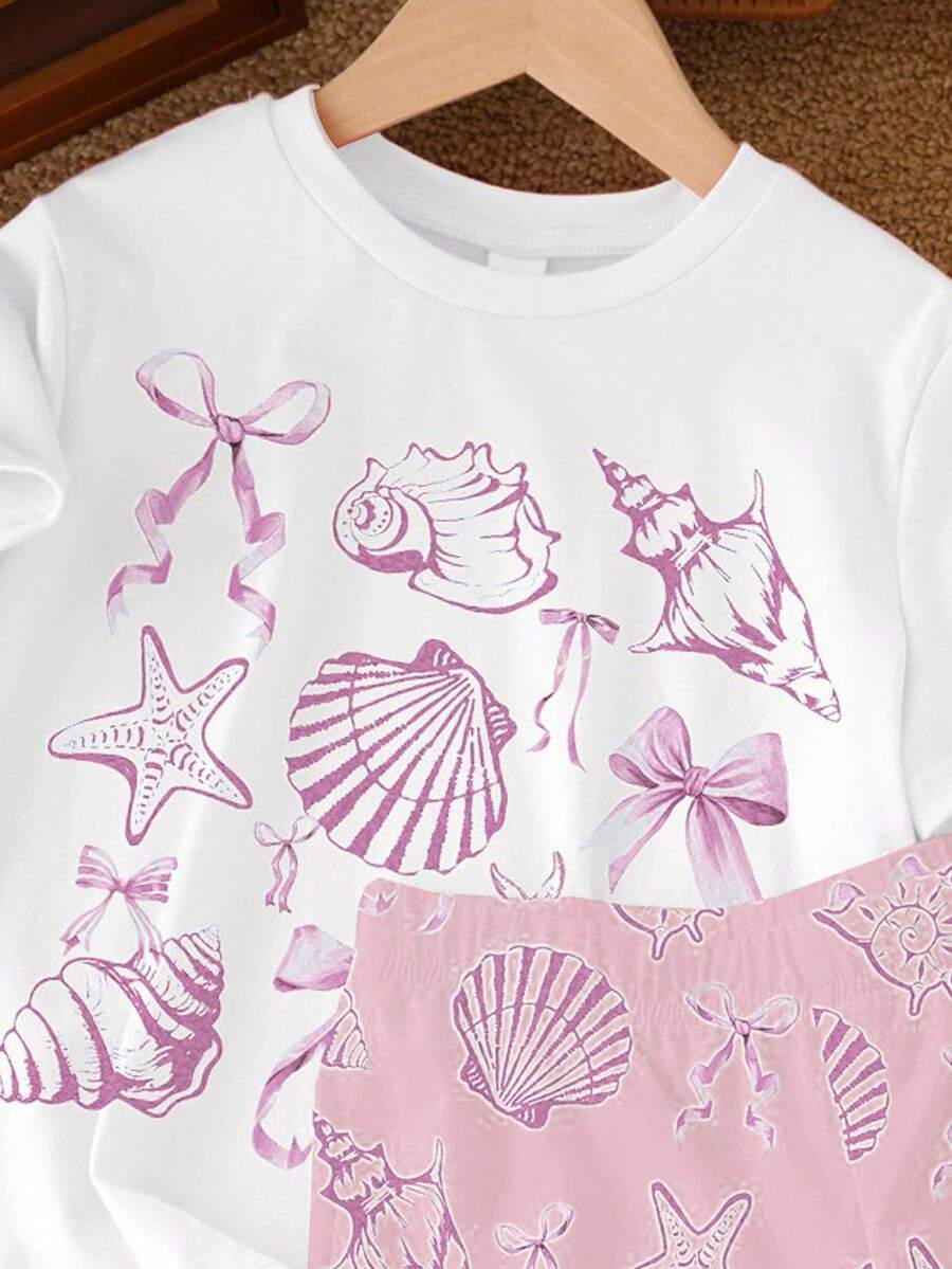 Teen girl wearing 2-piece summer vacation set with blue and white striped short sleeve top featuring seashell ocean bow print and matching loose fit shorts with pockets.