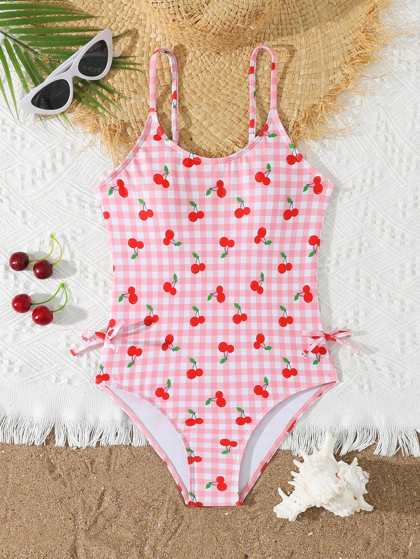 Tween girl plaid all-over print one-piece swimsuit with ruffle detail, spaghetti straps, fitted shape, and multicolor patchwork style for beach or pool wear.