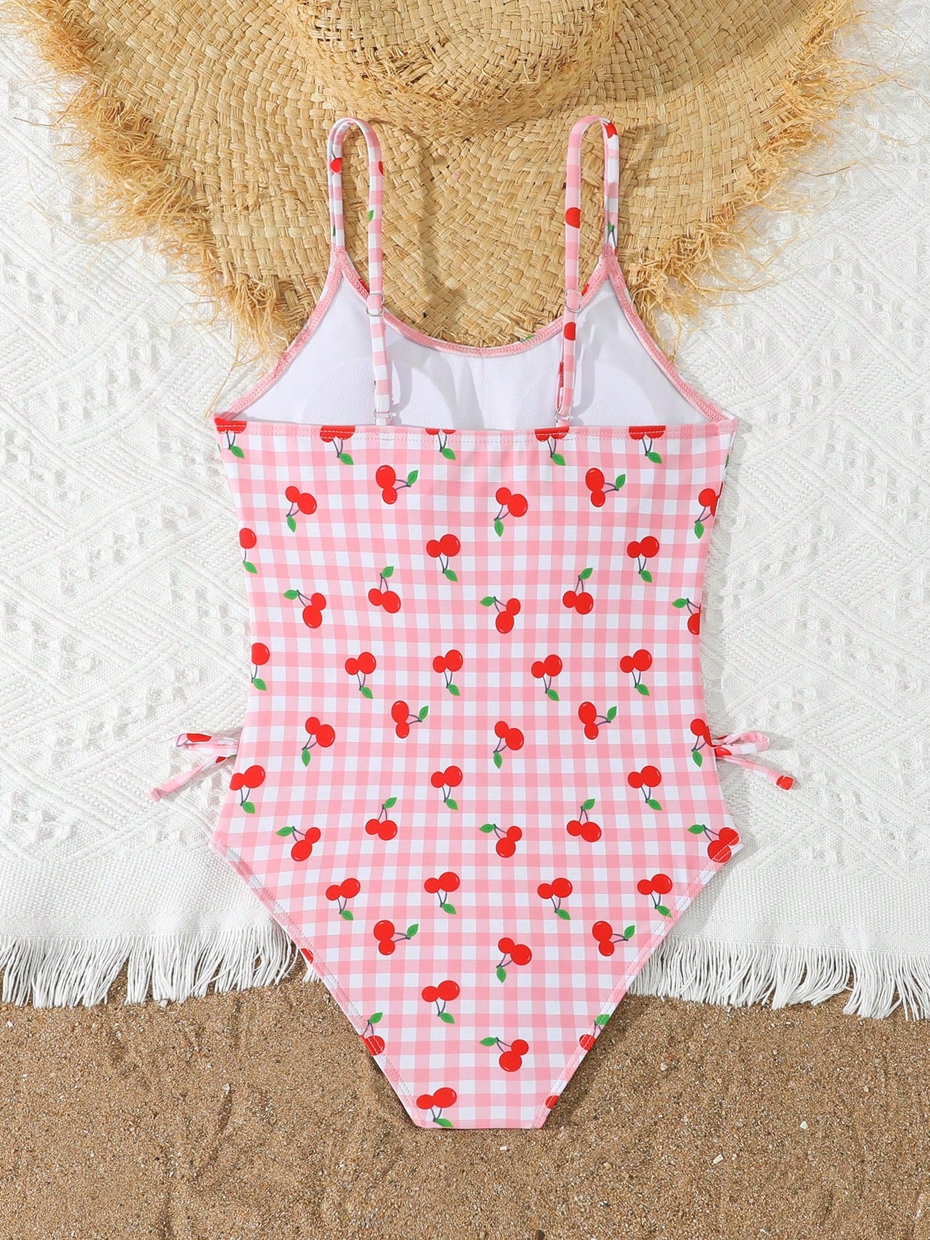 Tween girl plaid all-over print one-piece swimsuit with ruffle detail, spaghetti straps, fitted shape, and multicolor patchwork style for beach or pool wear.