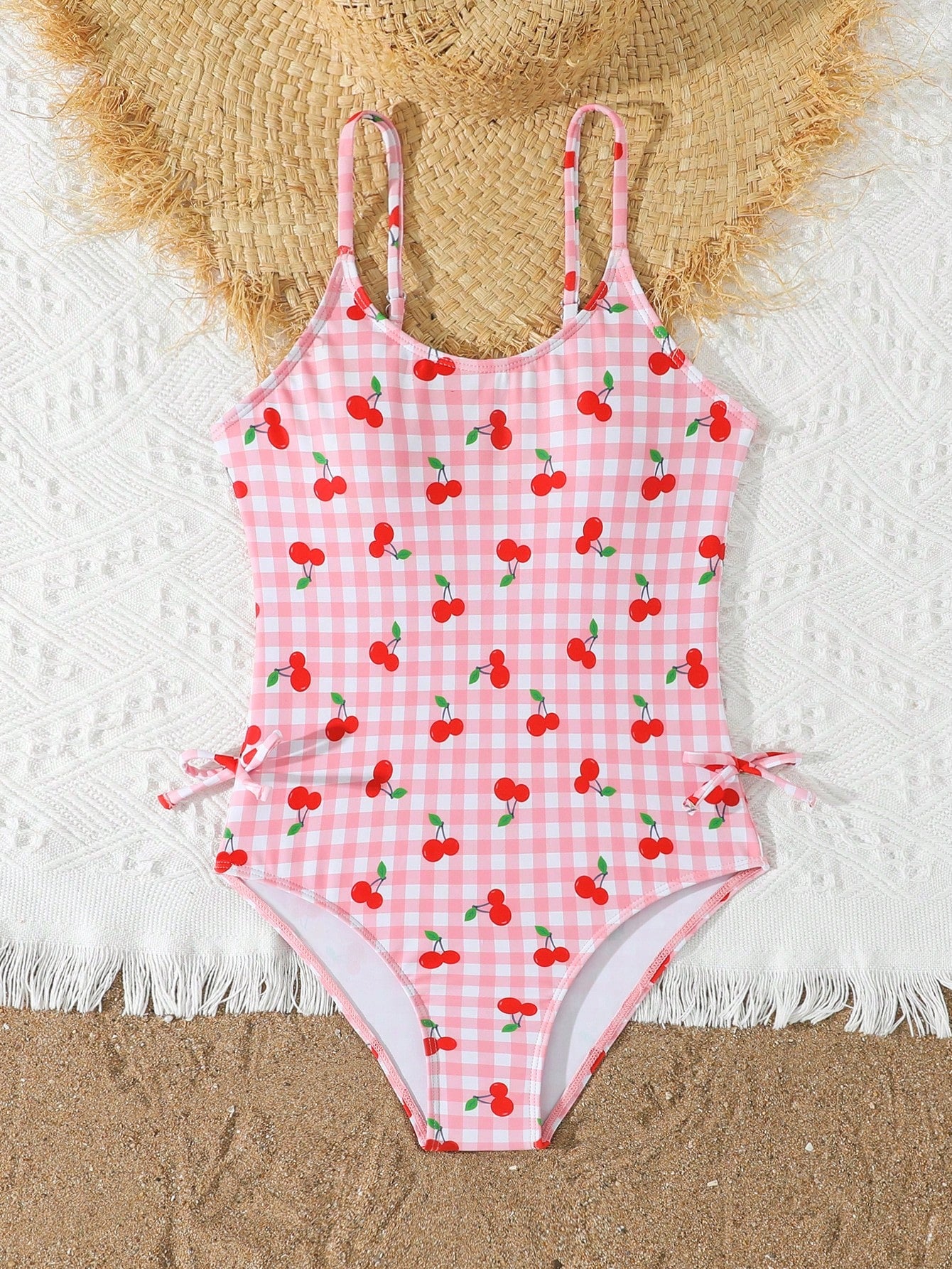 Tween girl plaid all-over print one-piece swimsuit with ruffle detail, spaghetti straps, fitted shape, and multicolor patchwork style for beach or pool wear.