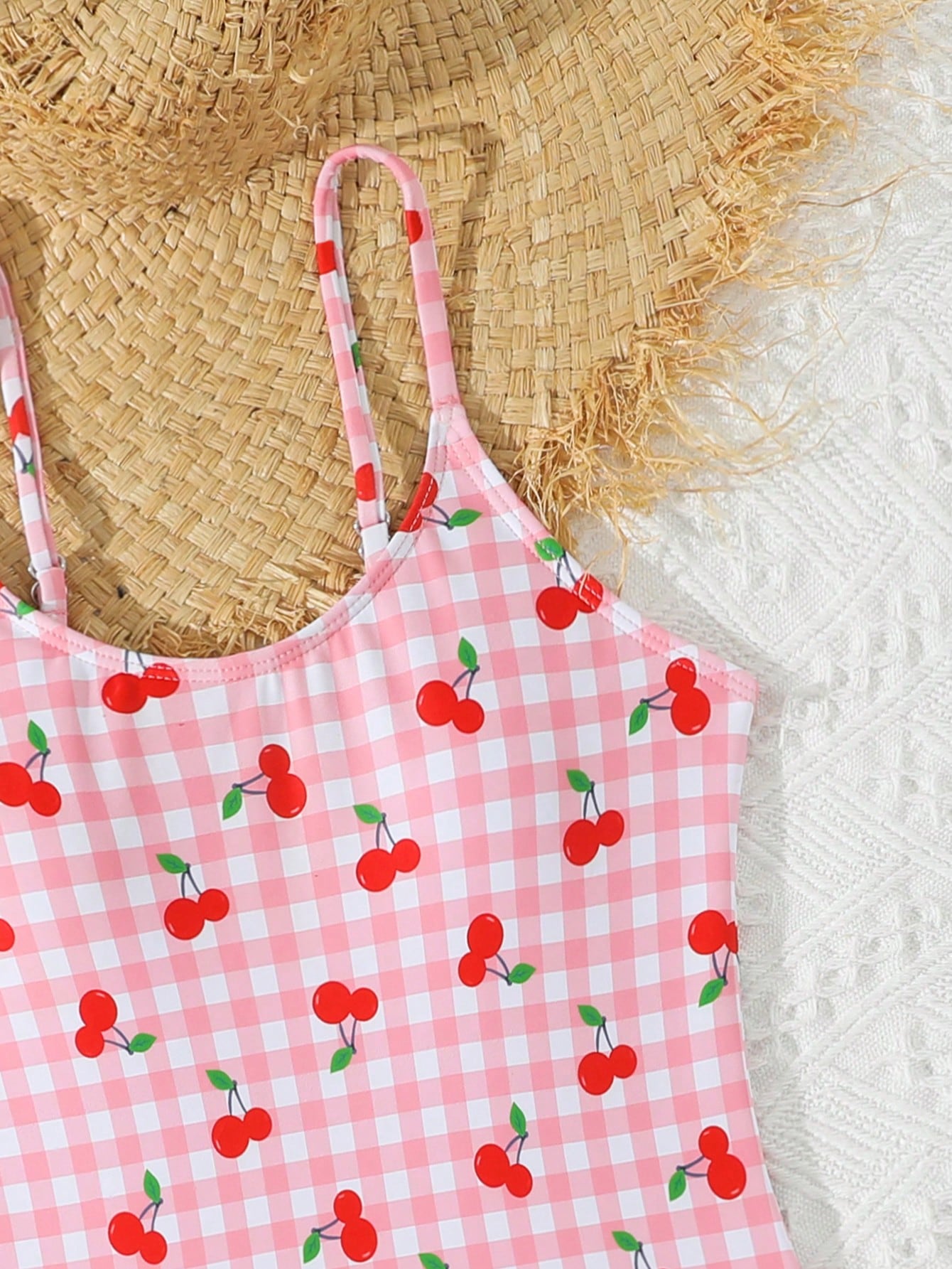 Tween girl plaid all-over print one-piece swimsuit with ruffle detail, spaghetti straps, fitted shape, and multicolor patchwork style for beach or pool wear.