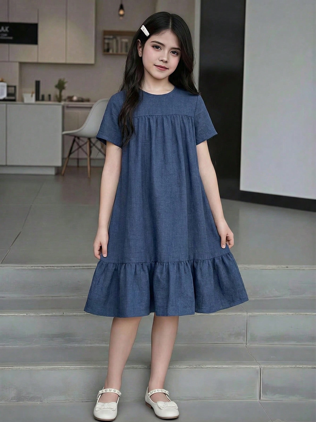 Tween girl wearing an Army Green textured short sleeve smock midi dress with round neck and ruffle flounce hem.
