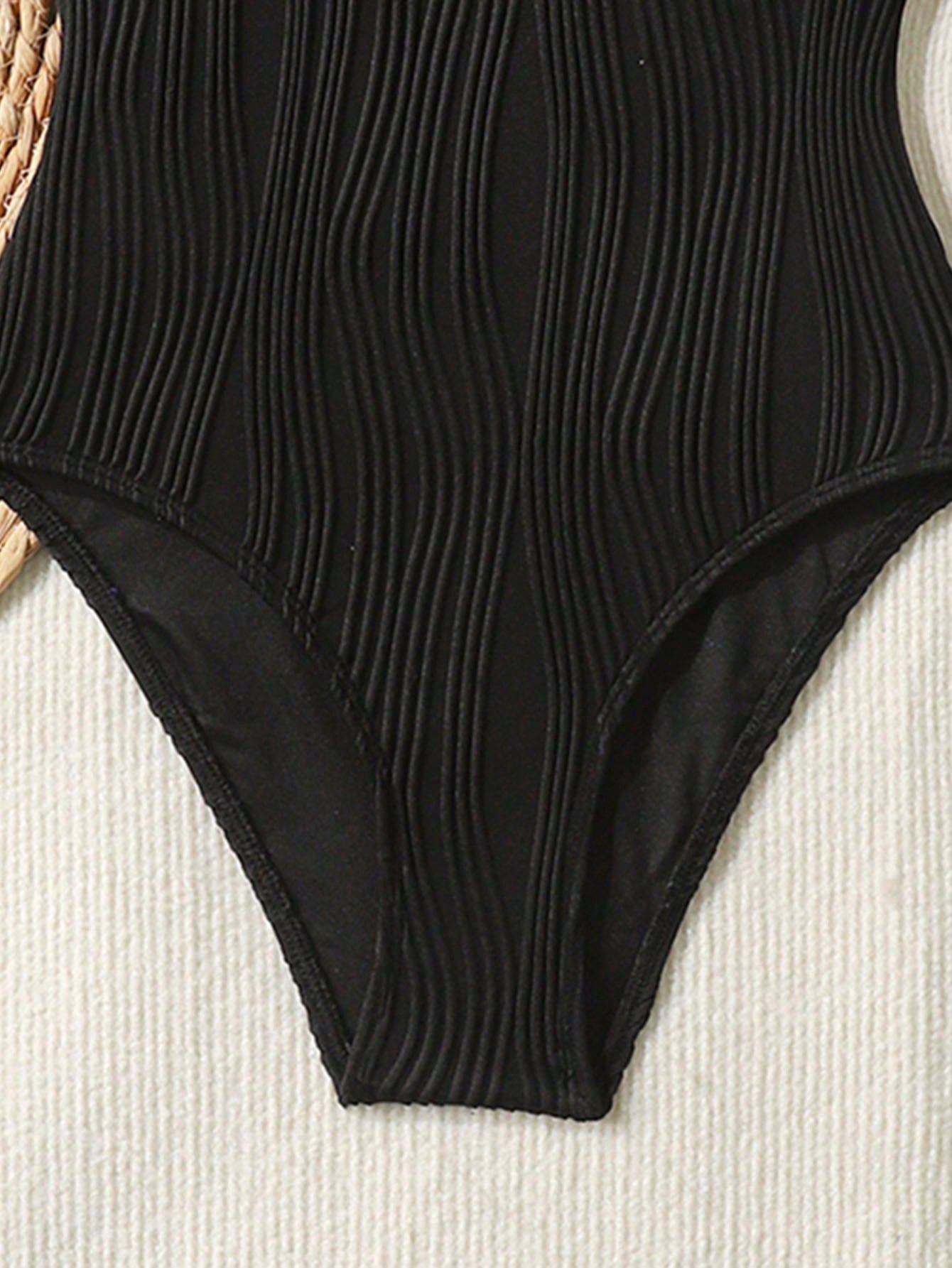 Tween girls black and white one-piece swimsuit with contrast piping, scoop neck, all-over print, and textured vacation style.