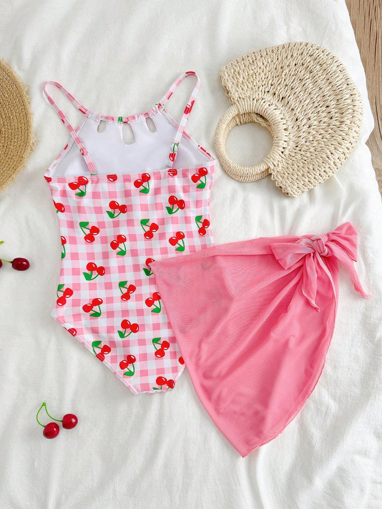 Girls black and white one-piece swimsuit set with cut-out detail, spaghetti straps, sleeveless fitted design, and matching skirt bottom for vacation swimwear.