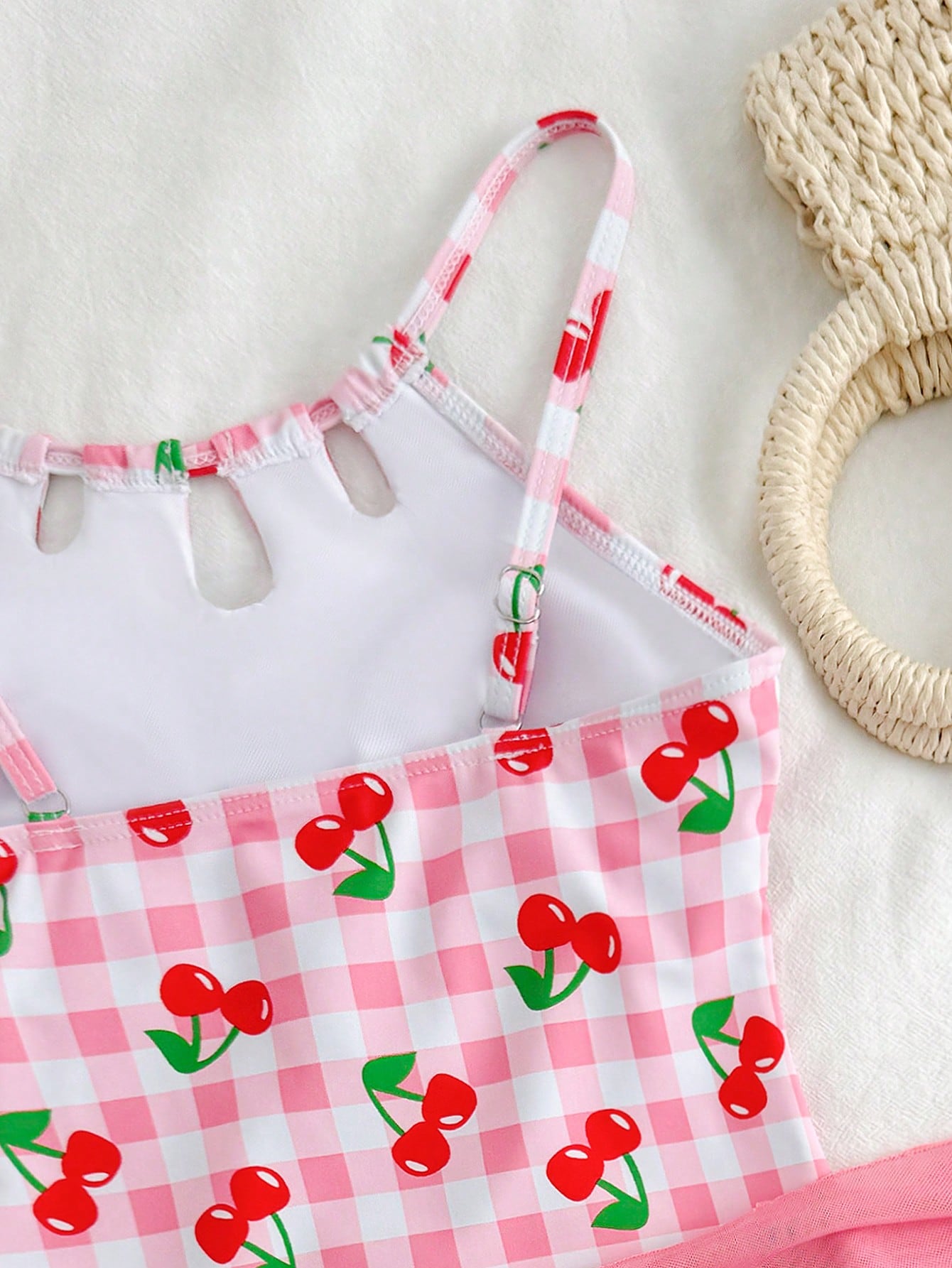 Girls black and white one-piece swimsuit set with cut-out detail, spaghetti straps, sleeveless fitted design, and matching skirt bottom for vacation swimwear.