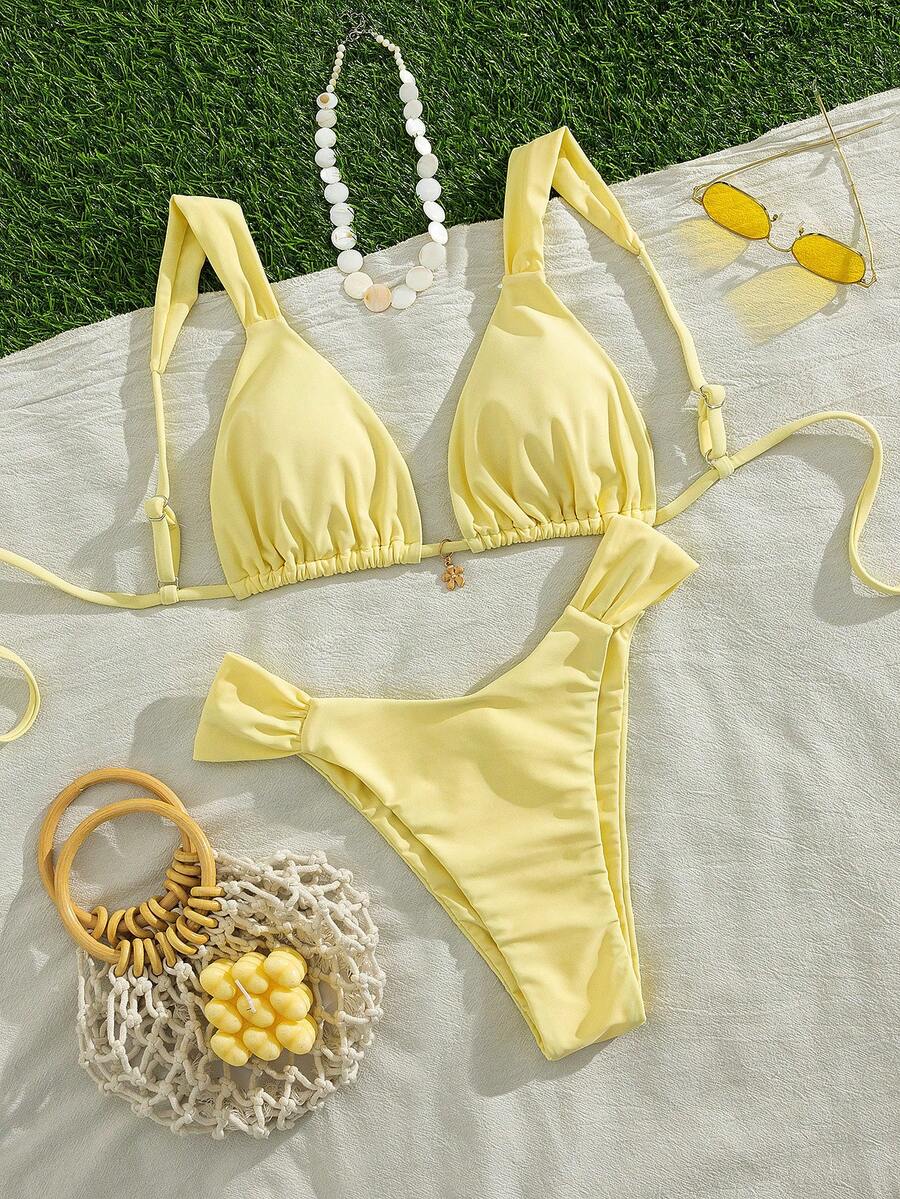 Women's solid yellow 2-piece bikini set featuring a high-waist bottom and a wireless bandeau top on display for beach and resort wear.