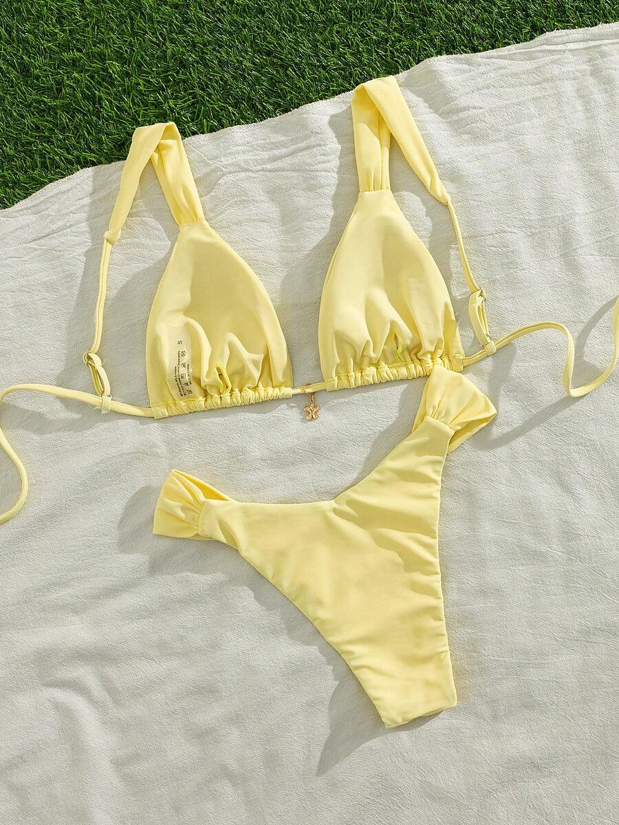 Women's solid yellow 2-piece bikini set featuring a high-waist bottom and a wireless bandeau top on display for beach and resort wear.