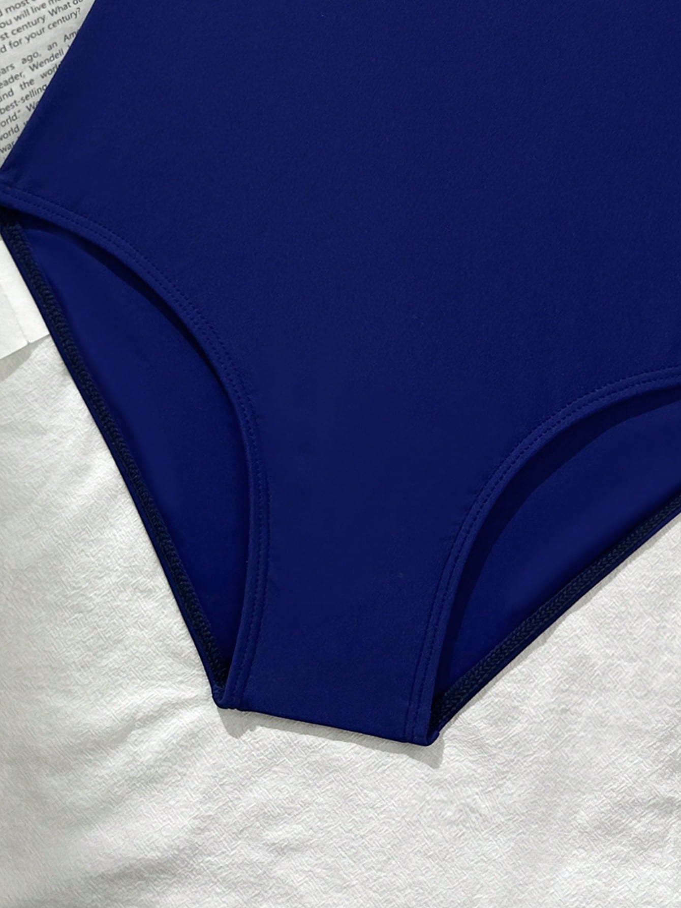 Tween girls' one-piece swimsuit featuring a ruffle splice front, ruched detailing, bow accent, contrast lace trim, and spaghetti straps.