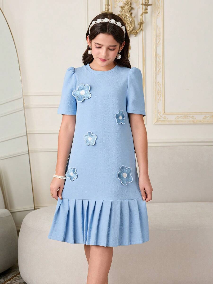 Tween girls apricot short-sleeve pleated smock dress with 3D bow decor and round neckline.