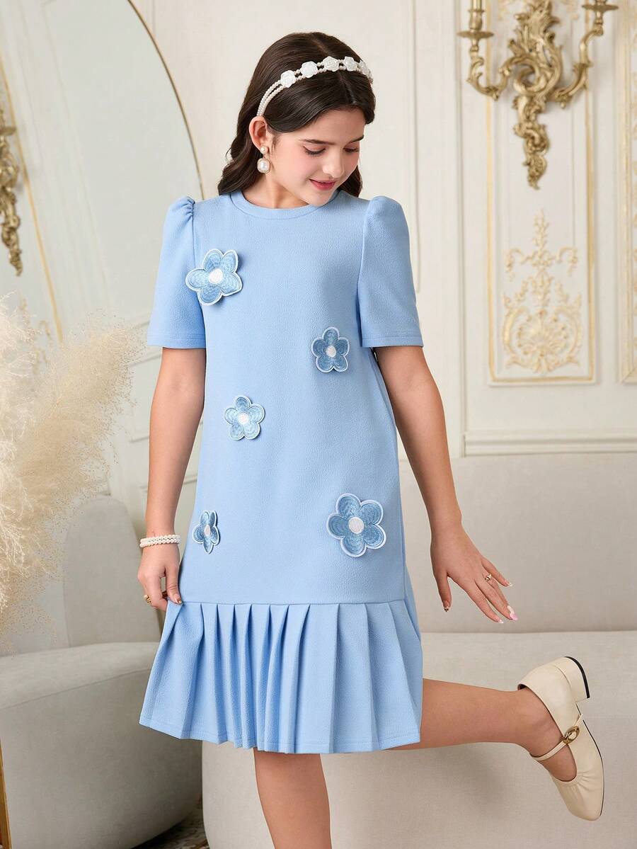 Tween girls apricot short-sleeve pleated smock dress with 3D bow decor and round neckline.