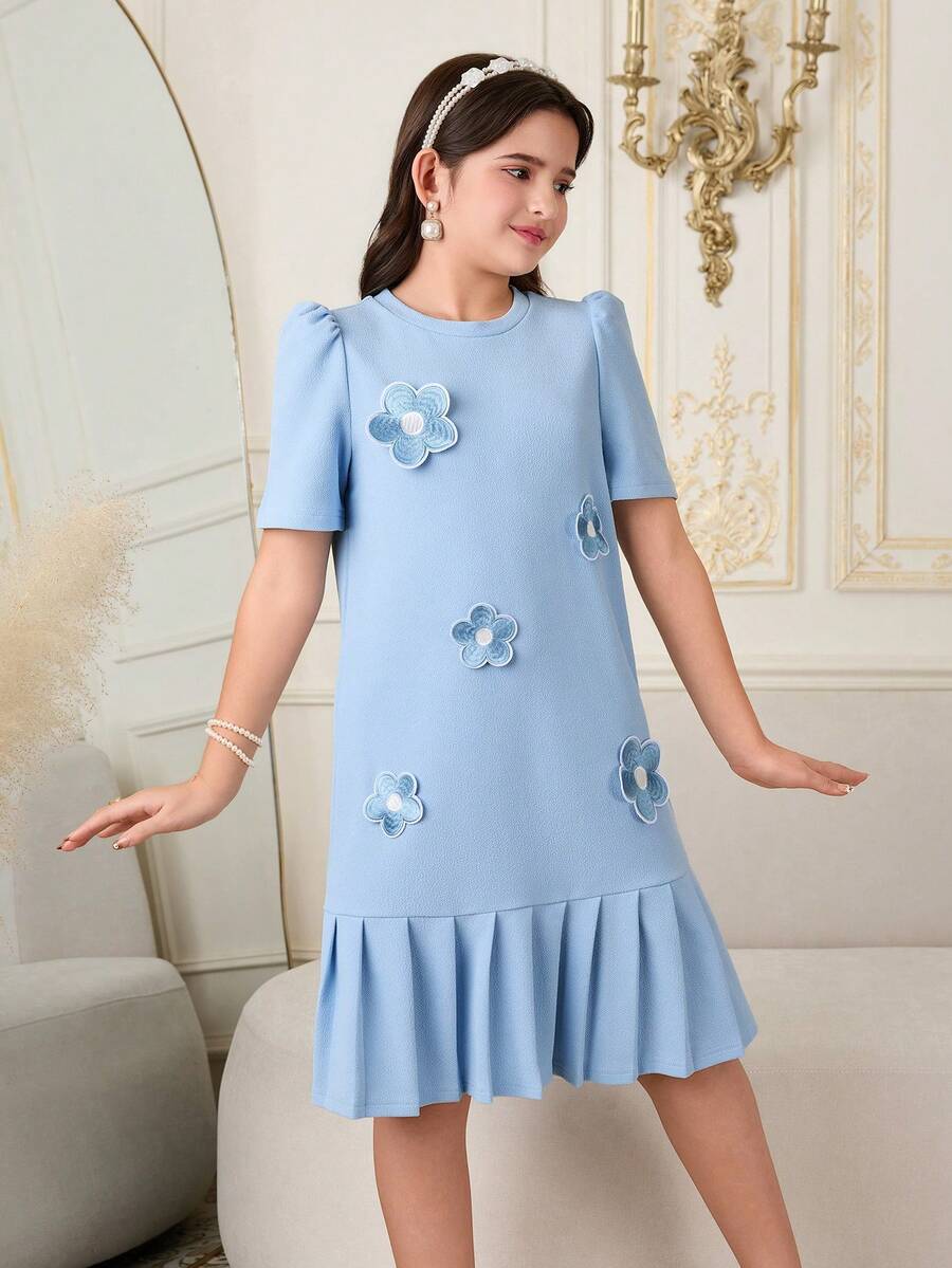Tween girls apricot short-sleeve pleated smock dress with 3D bow decor and round neckline.