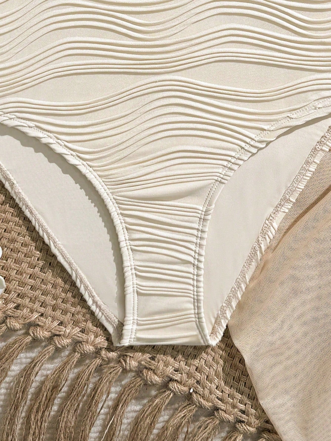 Blue girls one-piece swimsuit with spaghetti straps, textured plain fabric, shell-inspired detail, and matching skirt bottom for beach or pool vacation wear.