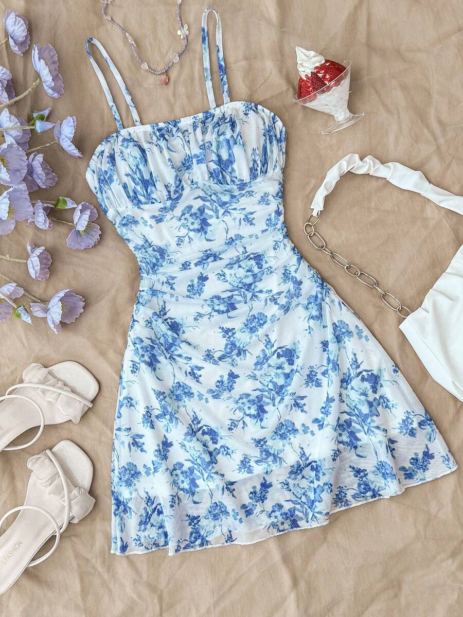Tween girl yellow mini sundress with large pink floral hibiscus print, spaghetti straps, high waist, flared hem, and sleeveless cami style for summer beach wear