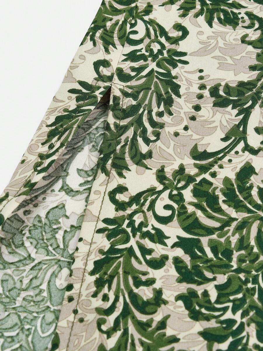 Tween girls green floral print cami dress with halter neckline, sleeveless cut, zipper detail, flared hem, and long vacation style silhouette.