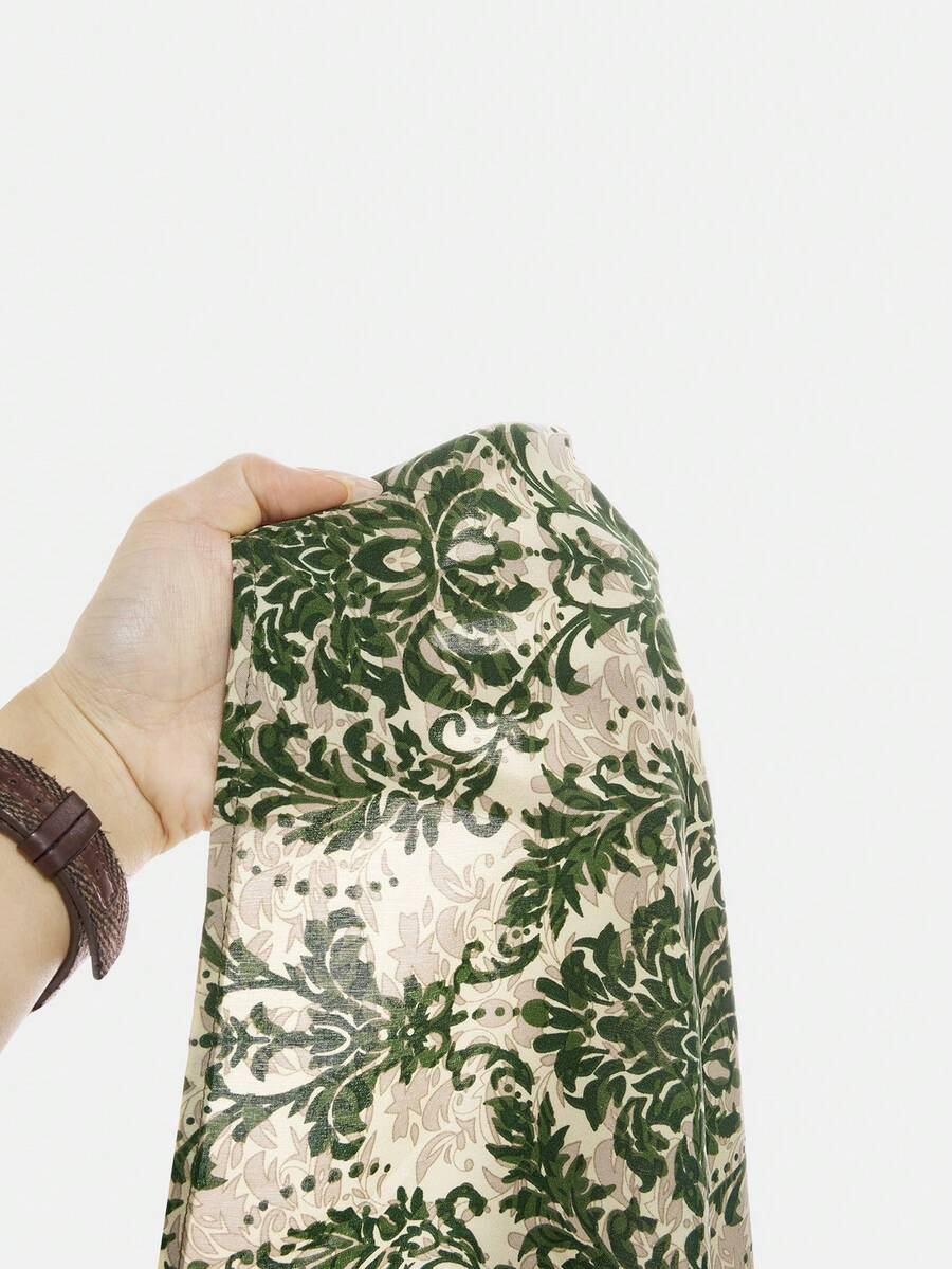 Tween girls green floral print cami dress with halter neckline, sleeveless cut, zipper detail, flared hem, and long vacation style silhouette.