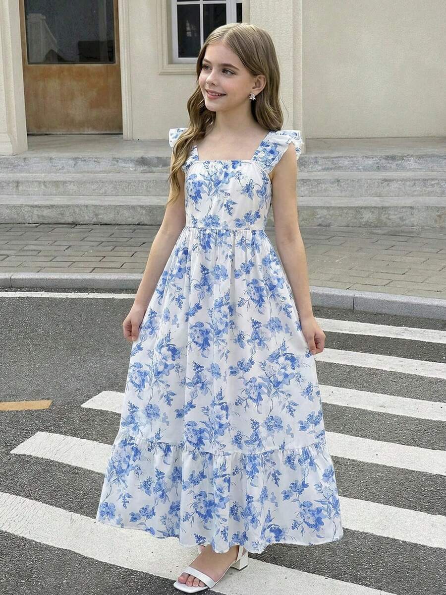 Blue floral print long vacation dress for tween girls featuring an A-line high waist silhouette with ruffle details and spaghetti straps.