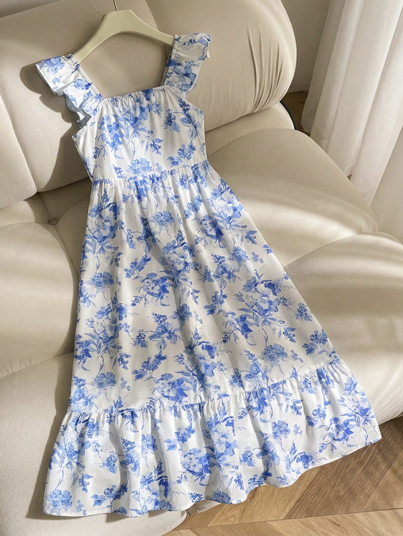 Tween girl multicolor floral vacation dress with square neck, ruffle details, shirred bodice, sleeveless A-line shape, high waist, and flounce hem.
