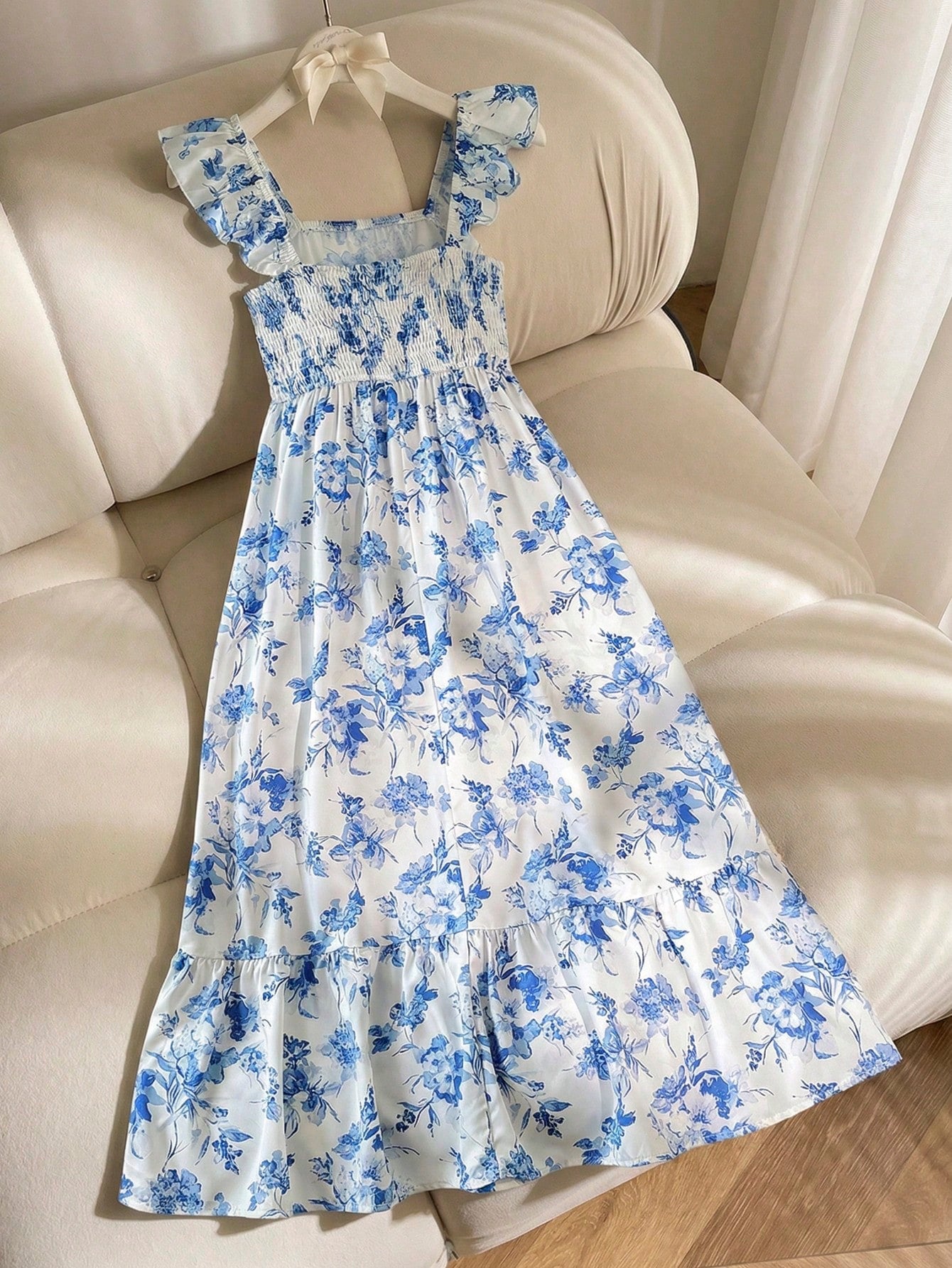 Tween girl multicolor floral vacation dress with square neck, ruffle details, shirred bodice, sleeveless A-line shape, high waist, and flounce hem.