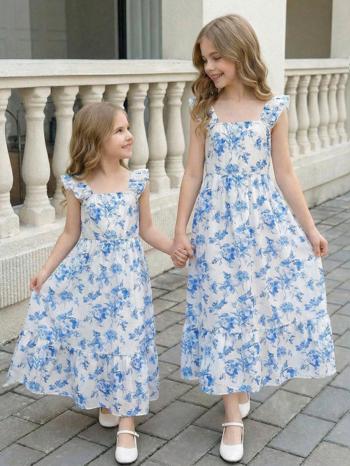 Tween girl multicolor floral vacation dress with square neck, ruffle details, shirred bodice, sleeveless A-line shape, high waist, and flounce hem.