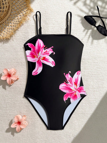 Tween girls one-piece swimsuit with a floral plant print, spaghetti straps, and a mid-waist fit in black.