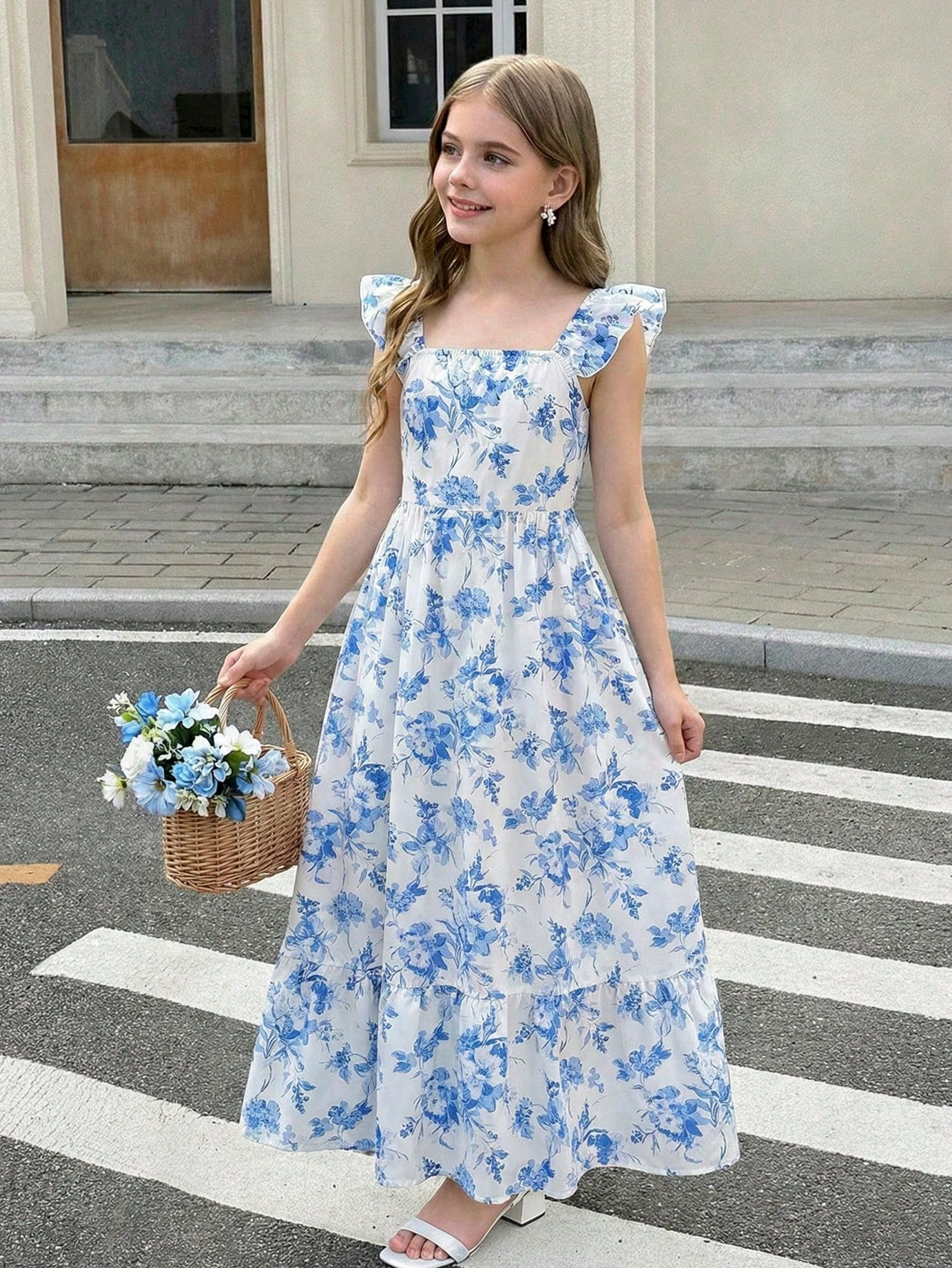 Tween girl multicolor floral vacation dress with square neck, ruffle details, shirred bodice, sleeveless A-line shape, high waist, and flounce hem.