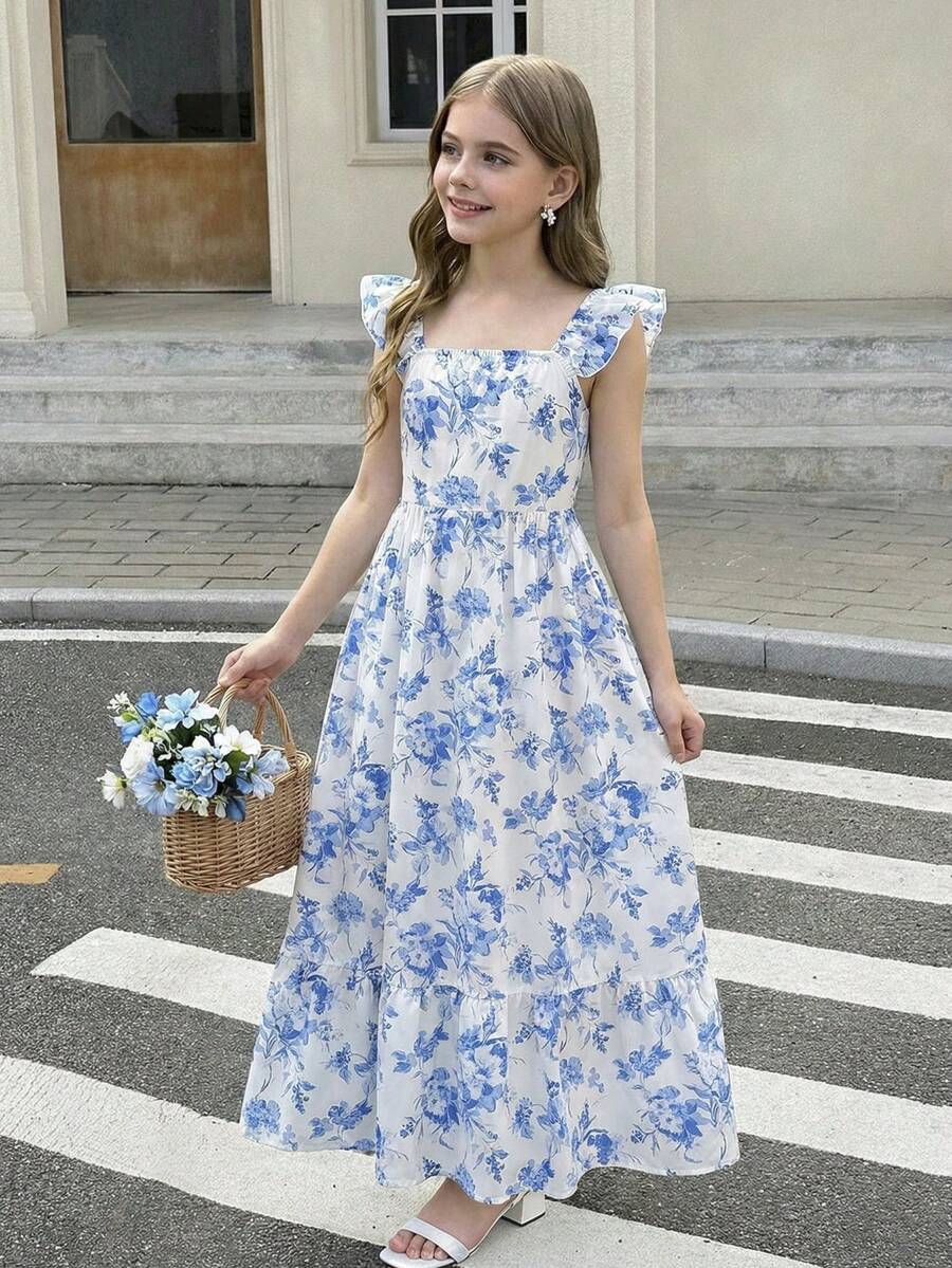 Blue floral print long vacation dress for tween girls featuring an A-line high waist silhouette with ruffle details and spaghetti straps.